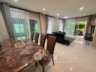 Spacious modern living room with elegant dining area and garden view