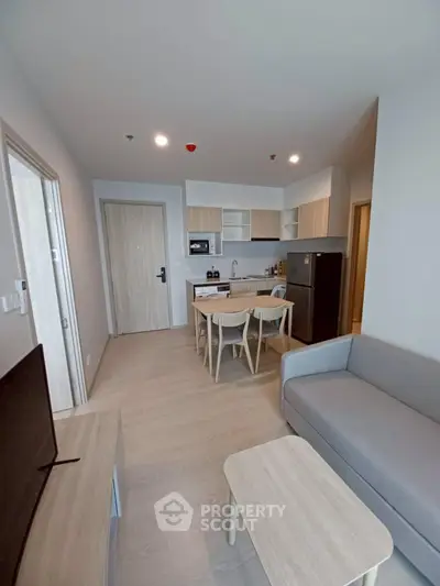 Modern open-plan living room with kitchen in stylish apartment