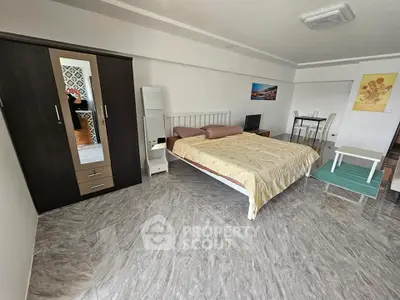 Spacious bedroom with modern decor and stylish flooring in a contemporary apartment.