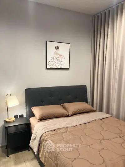 Cozy bedroom with elegant decor and soft lighting, featuring a stylish bed and modern nightstand.
