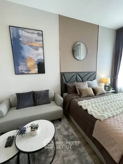 Modern bedroom with stylish decor and cozy seating area