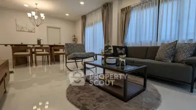 Spacious modern living room with elegant decor and dining area, perfect for family gatherings.