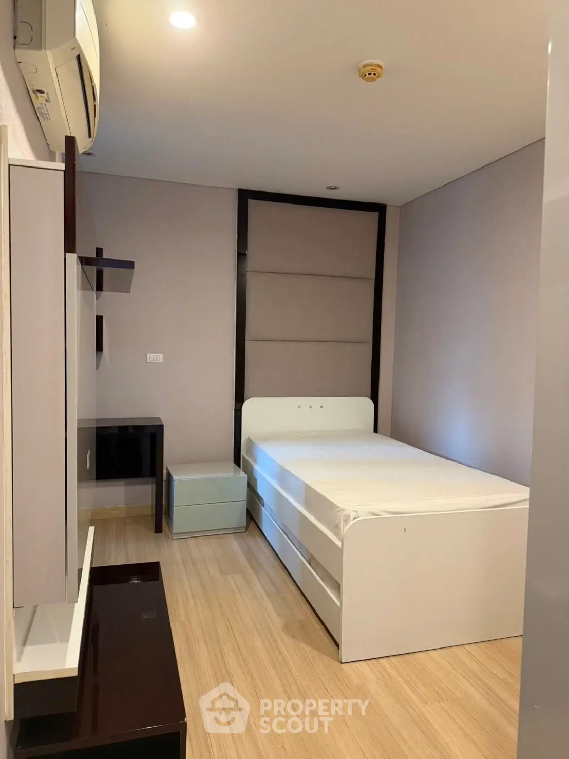 Modern minimalist bedroom with sleek furniture and ambient lighting