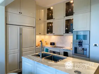 Elegant kitchen with marble countertops, modern appliances, and ample cabinet space, perfect for culinary enthusiasts.