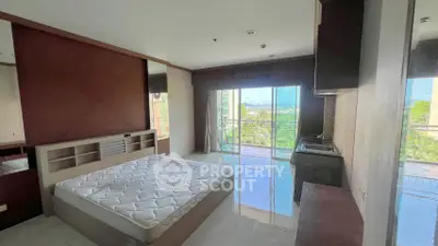 Spacious bedroom with balcony and scenic view in modern apartment