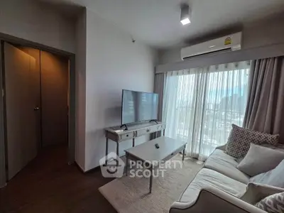 Modern living room with large window, cozy sofa, and sleek TV setup.