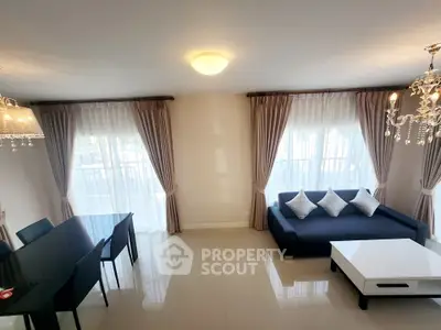 Elegant living room with modern decor and large windows for natural light