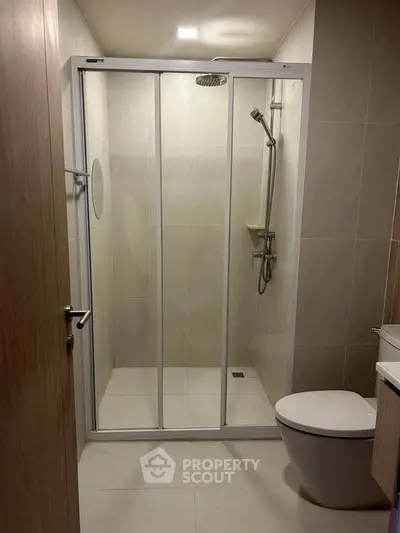 Modern bathroom with sleek shower enclosure and contemporary fixtures.