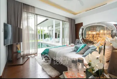 Luxurious bedroom with pool view and modern decor in a stunning villa.