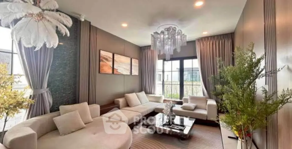 Luxurious modern living room with elegant decor and ample natural light.