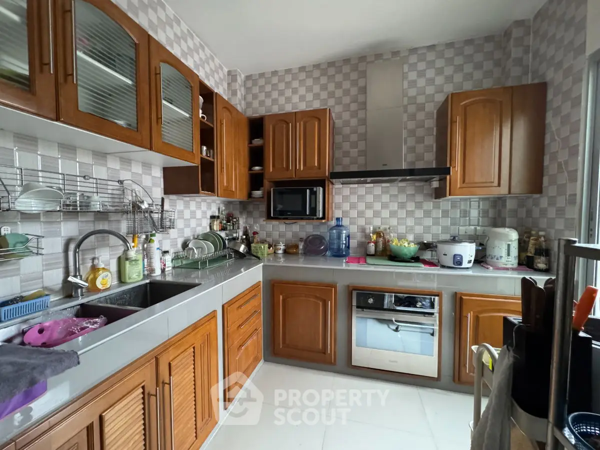 Spacious kitchen with wooden cabinets and modern appliances