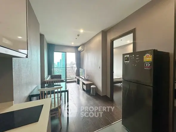 Modern apartment interior with open layout and city view from balcony.