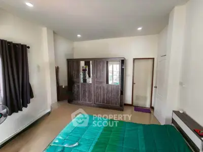 Spacious bedroom with modern wardrobe and cozy green bedding