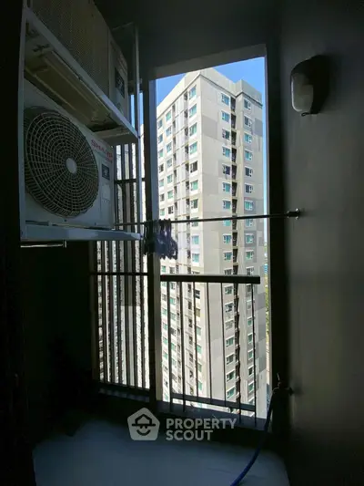 Urban apartment balcony with city view and air conditioning unit, ideal for modern living.