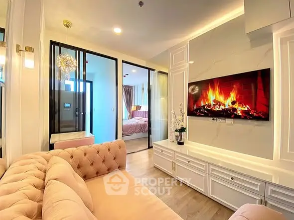 Luxurious living room with elegant decor and modern fireplace, leading to a cozy bedroom.