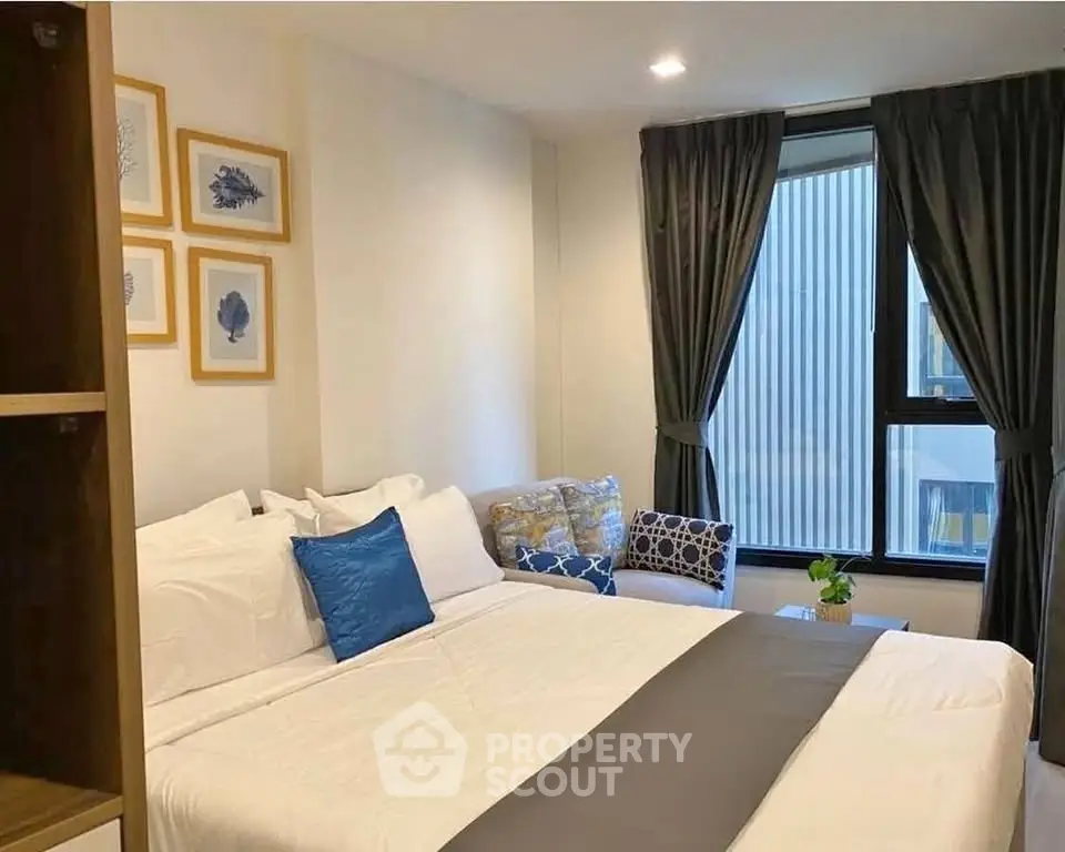 Cozy bedroom with elegant decor and large window for natural light