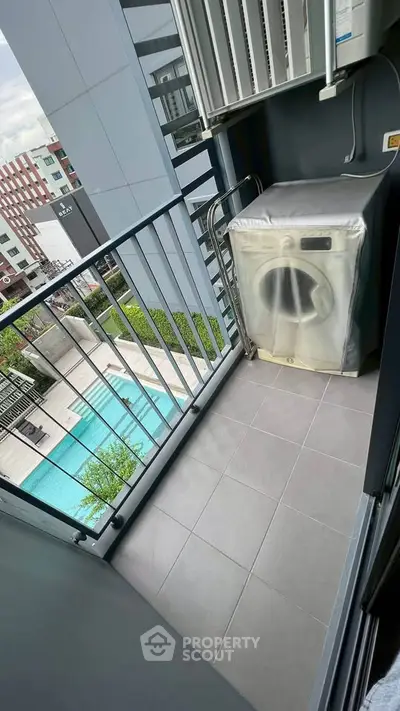 Modern balcony with washing machine and pool view in urban apartment