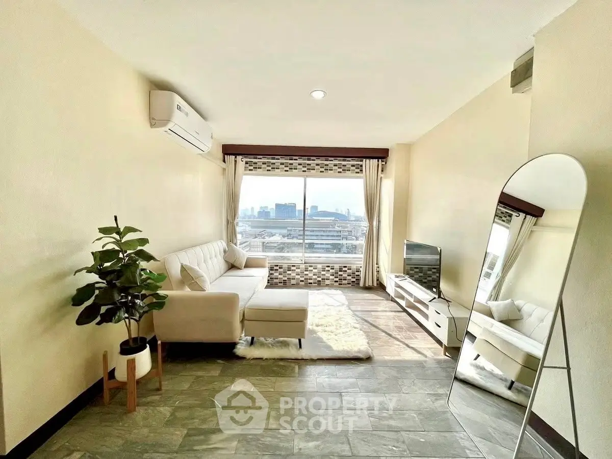 Bright living room with city view, modern furniture, and large mirror