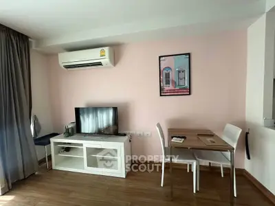 Cozy living room with modern decor, featuring air conditioning and a stylish dining area.