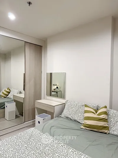 Cozy bedroom with modern decor and mirrored wardrobe