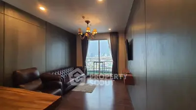 Spacious living room with elegant leather sofa and city view balcony, perfect for modern urban living.