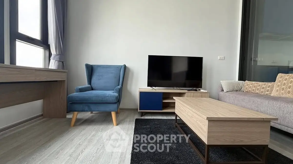 Modern living room with stylish furniture and large window