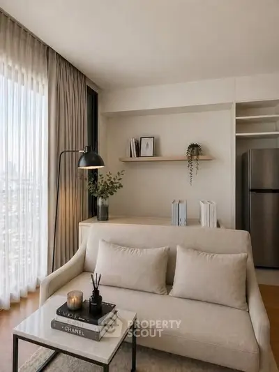 Stylish modern living room with cozy sofa, elegant decor, and large window offering city views.