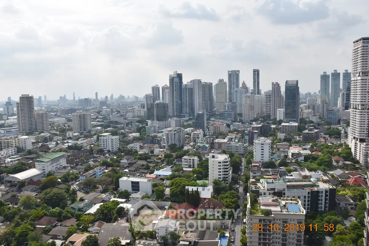 Stunning cityscape view showcasing a vibrant urban skyline with high-rise buildings and lush greenery.
