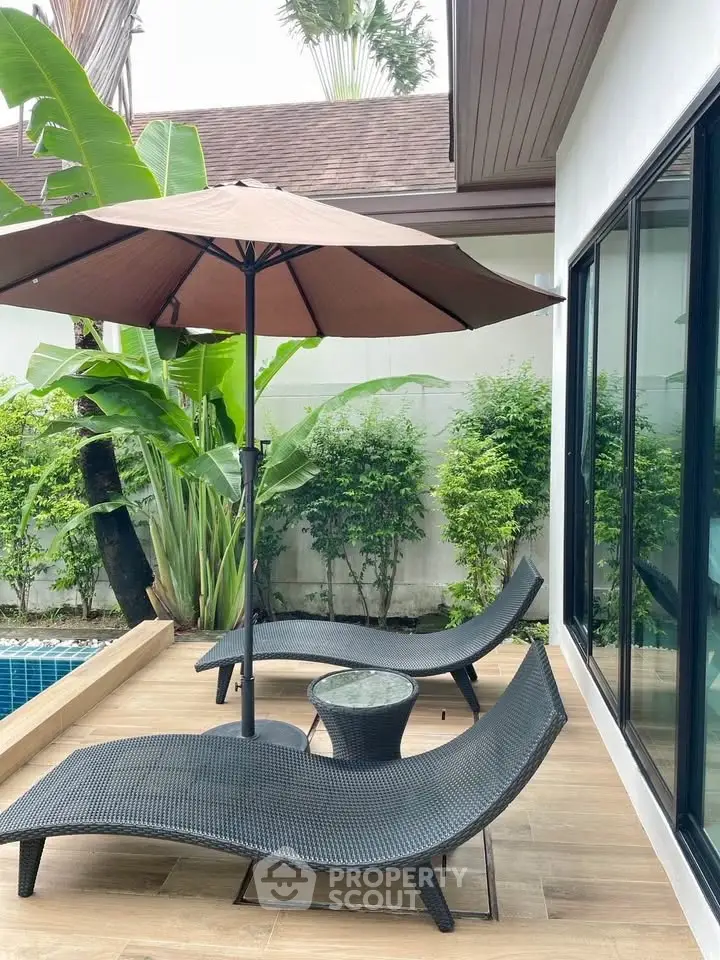 Charming poolside patio with stylish loungers and lush greenery, perfect for relaxation and outdoor enjoyment.
