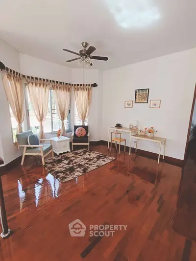 Charming living room with elegant decor and large windows offering natural light.