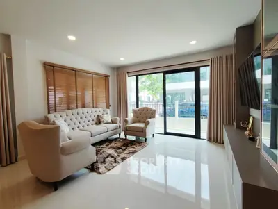 Spacious living room with elegant furniture and large windows for natural light.