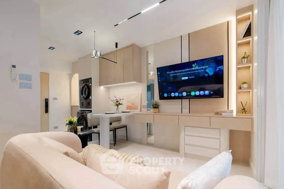 Modern living room with sleek design, built-in TV, and cozy seating area.