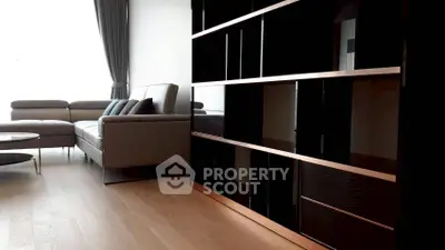 Modern living room with sleek black shelving and stylish gray sofa