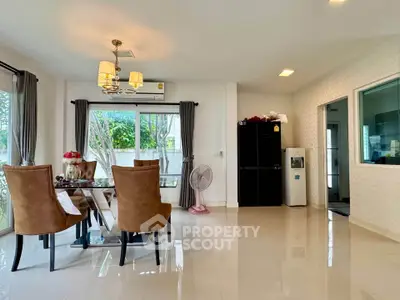 Spacious dining area with elegant chairs and large windows in modern home