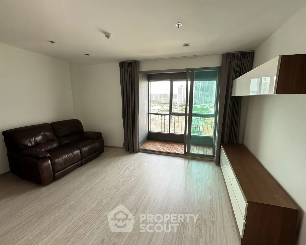 Spacious living room with balcony view in modern apartment