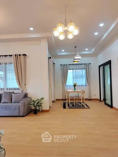 Spacious modern living room with elegant lighting and cozy dining area