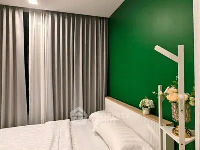 Modern bedroom with green accent wall and elegant decor