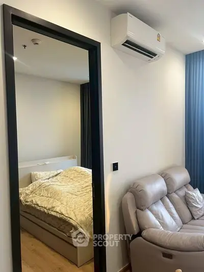 Modern apartment interior with cozy bedroom and stylish living area featuring air conditioning.