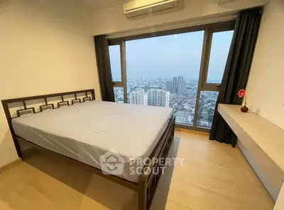 Spacious bedroom with stunning city view and modern furnishings