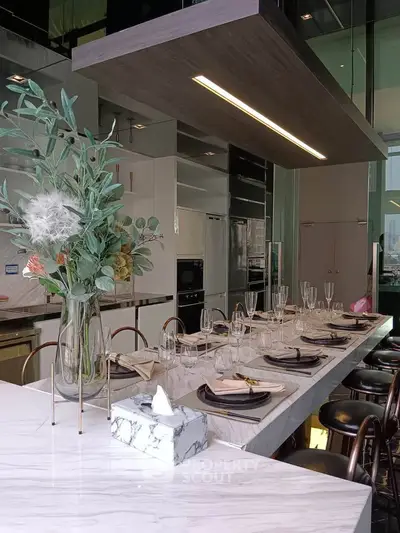 Luxurious modern kitchen with elegant marble island and stylish dining setup