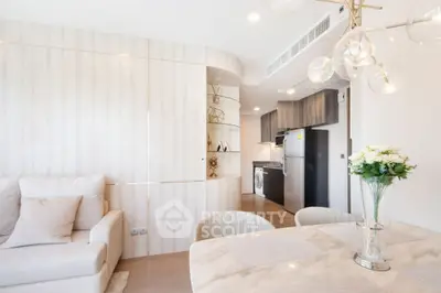 Modern open-plan living room and kitchen with elegant decor and natural light