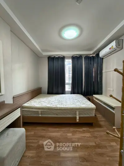 Spacious bedroom with modern furnishings and natural light