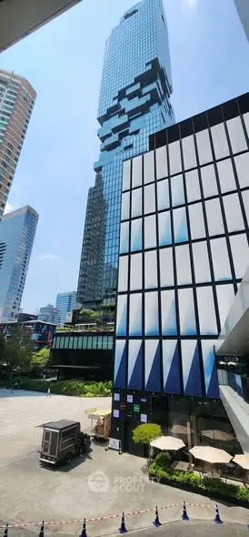 Stunning view of modern skyscrapers with unique architectural design in a bustling urban setting.