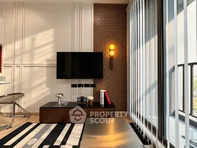 Modern living room with stylish decor and large windows offering natural light.