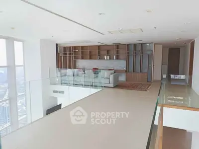 Luxurious modern living room with floor-to-ceiling windows and elegant decor in high-rise apartment.