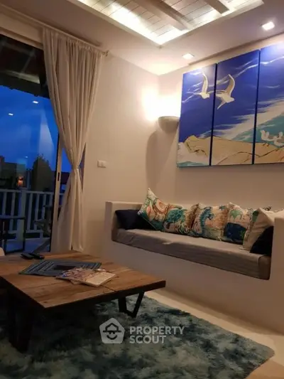 Charming living room with cozy seating and artistic decor, perfect for relaxation.