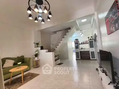 Spacious living room with modern decor and staircase in a stylish home