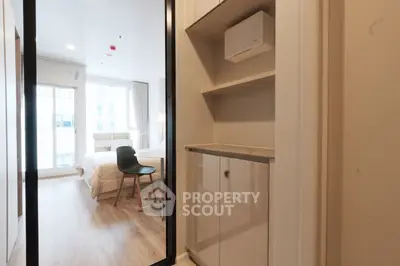 Modern bedroom with sleek design and ample natural light, featuring a cozy workspace and stylish furnishings.