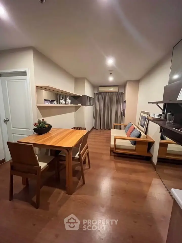 Modern living room with wooden flooring and stylish furniture in a cozy apartment setting.