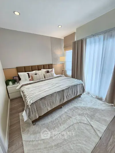 Elegant bedroom with cozy decor and natural light, featuring a plush bed and stylish curtains.